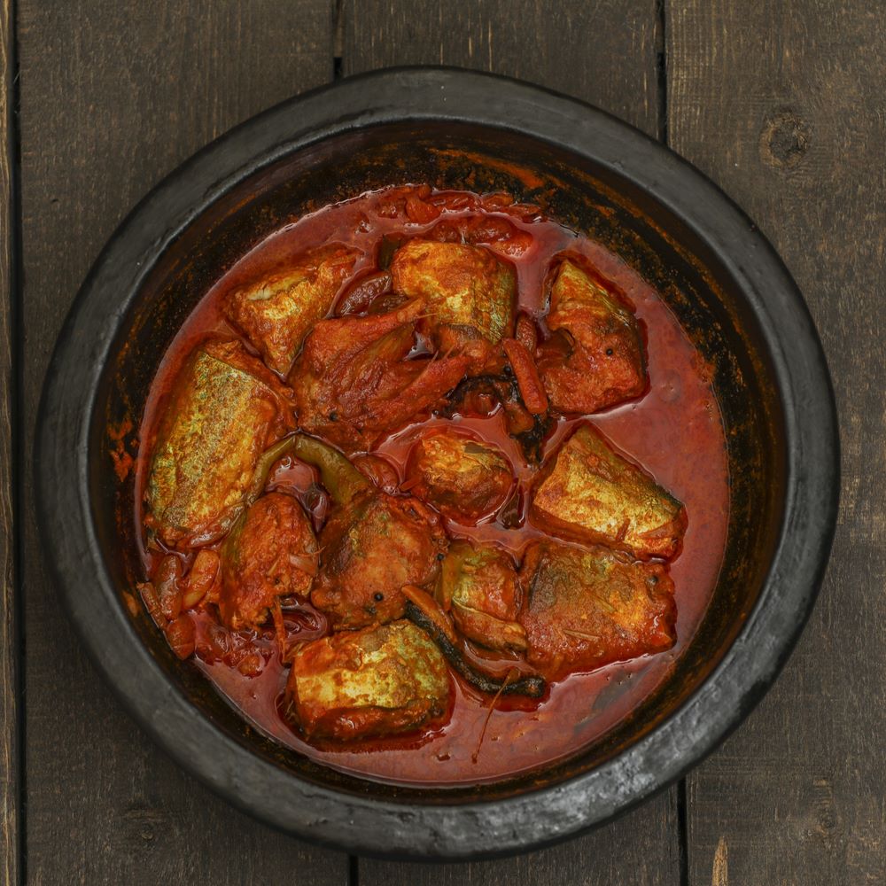 Ayala Curry in a clay pot on a wooden table