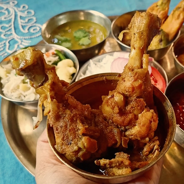 Chicken Kasha along with other dishes in a thali