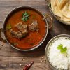 Mutton Ki Sabji with ghee rice and Malabar parathas on the side.