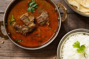 Mutton Ki Sabji with ghee rice and Malabar parathas on the side.