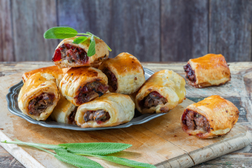 Homemade,Sausage,,Cranberry,,Chestnut,And,Sage,Rolls Sausage rolls on a plate