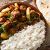 Murgh Do Pyaza on a plate paired with rice and roti.