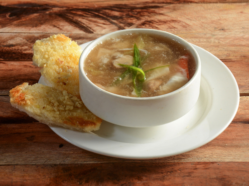 Chicken,Talumein,Soup,,Indo,Chinese,Dish,Served,Over,A,Rustic Chicken,Talumein Soup in a white soup bowl